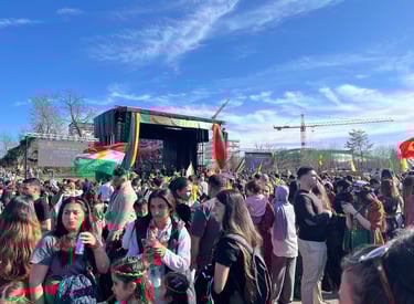 a crowd of people standing around a stage