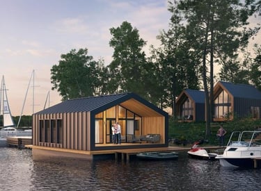 Modern floating house and lakeside cabins with boats docked at a scenic waterfront resort.