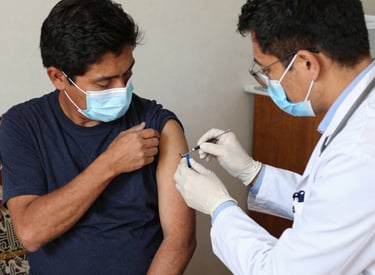 A doctor and an interpreter kindly assisting a migrant patient in a clinic setting.
