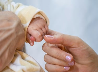 a baby's hand holding a baby's finger