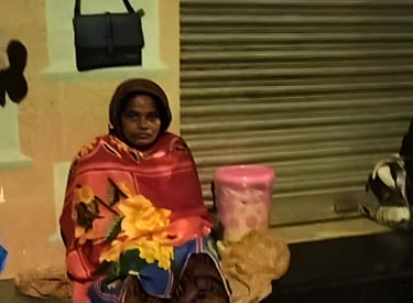a woman sitting on a bench in front of a building
