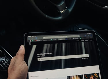 A person holding a tablet computer and a tablet looking at an elegant website.