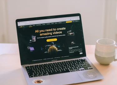 A laptop computer sitting on a table with a cup of coffee looking at a website.