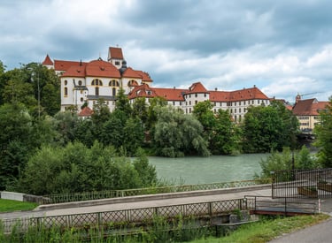 The High Castle of Fussen and St. Mang's Abbey overlooking the Lech River in Germany.