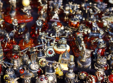 Collection of small bronze animal figurines and vintage ornaments with amber stone details.