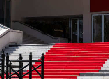 Iconic red carpet stairs at the Palais des Festivals in Cannes for a film festival premiere event.