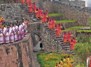 Performers in traditional Andean dress descend stone stairs during an Inti Raymi festival at Qorikancha, Peru.