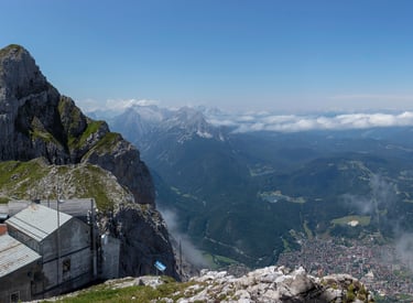 Panoramic view of Garmisch-Partenkirchen from the rocky summit of Zugspitze in the Bavarian Alps.