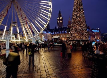 Crowds visit a festive Christmas market at night with a lit Ferris wheel and glowing holiday tree.