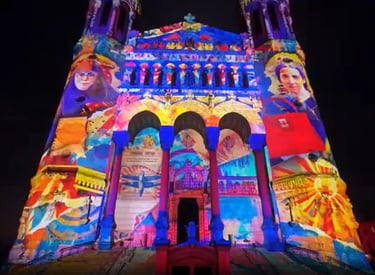 Vibrant light projection mapping on the facade of Lyon's Basilica of Notre-Dame de Fourvière at night.
