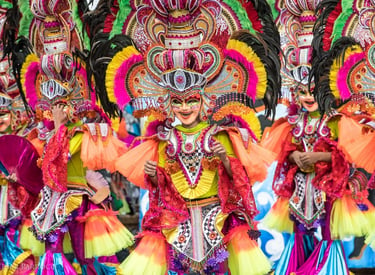 Performers in colorful masks and feathered costumes at the MassKara Festival in Bacolod City.