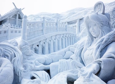 Intricate snow sculpture of a woman and a bridge at the Sapporo Snow Festival in Japan.