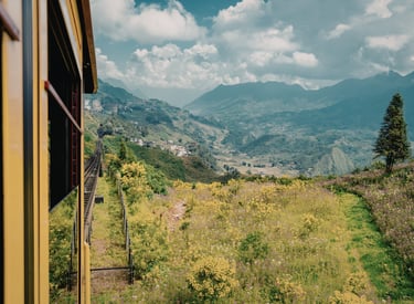 Muong Hoa Valley view from the Sapa mountain train window in Vietnam with lush green hills.