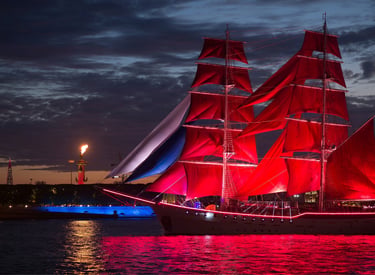 A majestic tall ship with illuminated scarlet sails at the Scarlet Sails festival in Saint Petersburg.