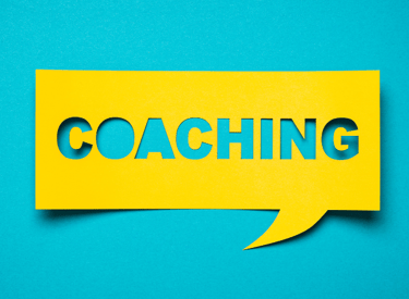 a yellow speech bubble with the word coaching on it
