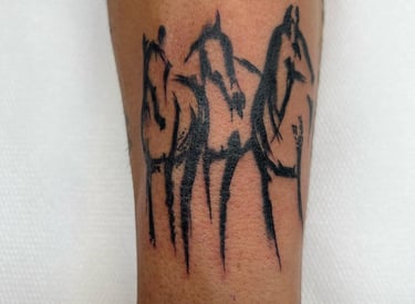 a tattoo of a horse and a horse on a man's leg made at Inari Tattoo