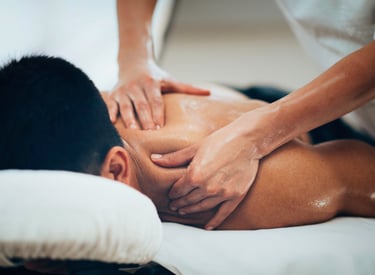 Massage therapist applying firm pressure during a therapeutic back massage