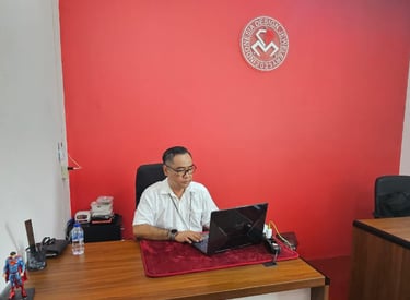 a man sitting at a desk with a laptop computer