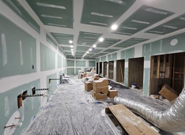 a room with drywall repairs and spackled walls