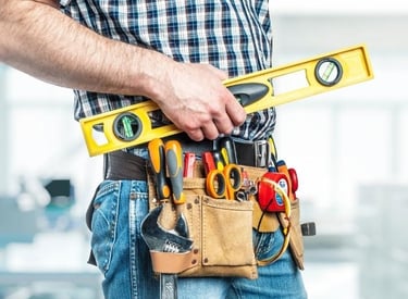 a man in a tool belt belt holding a tool belt