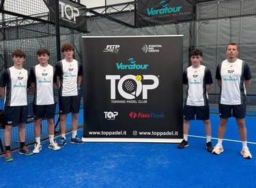 Padel players posing on a blue indoor court by a Torrino Padel Club sponsor banner.