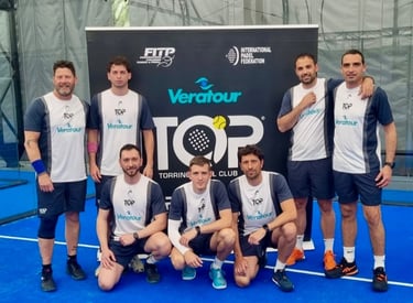 A group of male padel players in Veratour team uniforms posing on a blue indoor padel court.