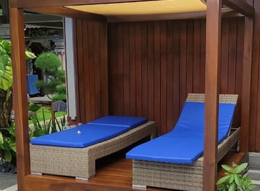 a couple of lounge chairs sitting next to a pool