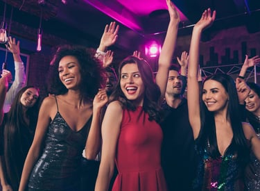 Group of friends dancing and enjoying a vibrant night out at a Las Vegas club crawl event.