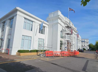 Exterior painting of large white commercial building with scaffolding in Croydon, Pure Perfection