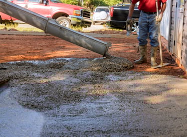 a man is pouring cement into a concrete wall