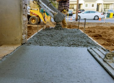 a man is pouring concrete into a concrete slab