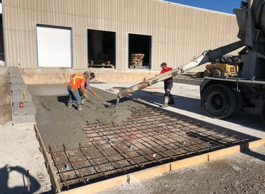 a man is pouring concrete into a concrete slab