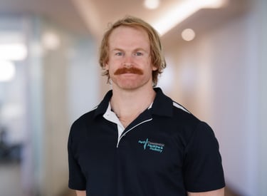 Advanced Sports Osteopath Dr Ashby Smith posing for a headshot at Perth Osteopathic Medicine
