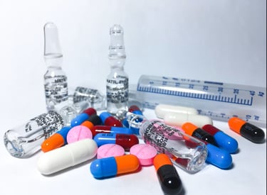A collection of various pills and capsules, including a prominent green gel capsule and a heart-shap