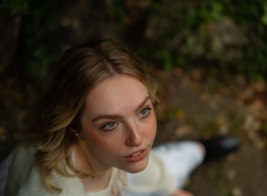 woman sitting in the forest looking up