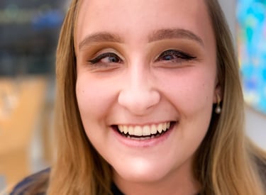 A blond-haired woman founder Zhenya Pankova, smiles at the camera.