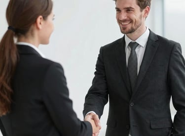 Smiling client shaking hands with a male Recovery expert.