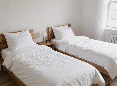 Exterior view of a cozy home with a muted blue-gray facade surrounded by greenery.