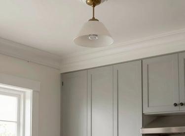 A friendly handyman installing elegant crown molding in a cozy living room.