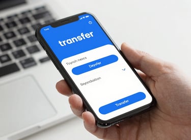 Person using a laptop to make a bank transfer payment with a cup of tea nearby.