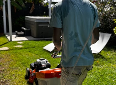 a man is walking around a lawn with a lawnmower