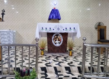 A Catholic church altar with a purple Lenten cloth, religious embroidery, and an Advent wreath.