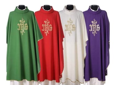 A set of liturgical chasubles in green, red, white, and purple with gold IHS embroidery for church clergy.