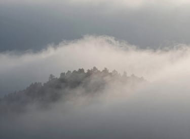 A cozy recording setup with microphones and headphones, surrounded by softly glowing candles.