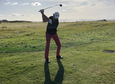 a man playing golf on a sunny day in scottland