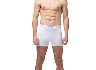 Athletic man wearing white cotton boxer briefs for men with a comfortable elastic waistband.