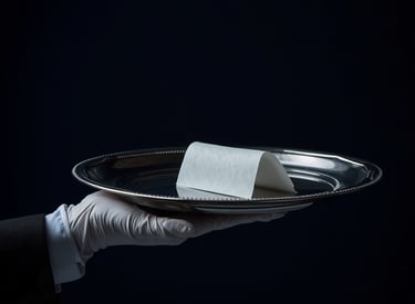White gloved hand holding silver tray with note luxury concierge butler service Milestone Creator