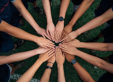 Group of hands joined together in circle team gathering friend event experience Milestone Creator