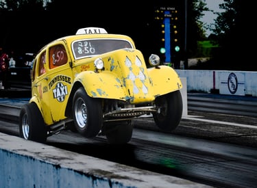 YELLOW OLD TAXI STYLE DRAG CAR WITH WHEELS UP