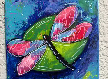 a painting of a dragonfly on a canvas